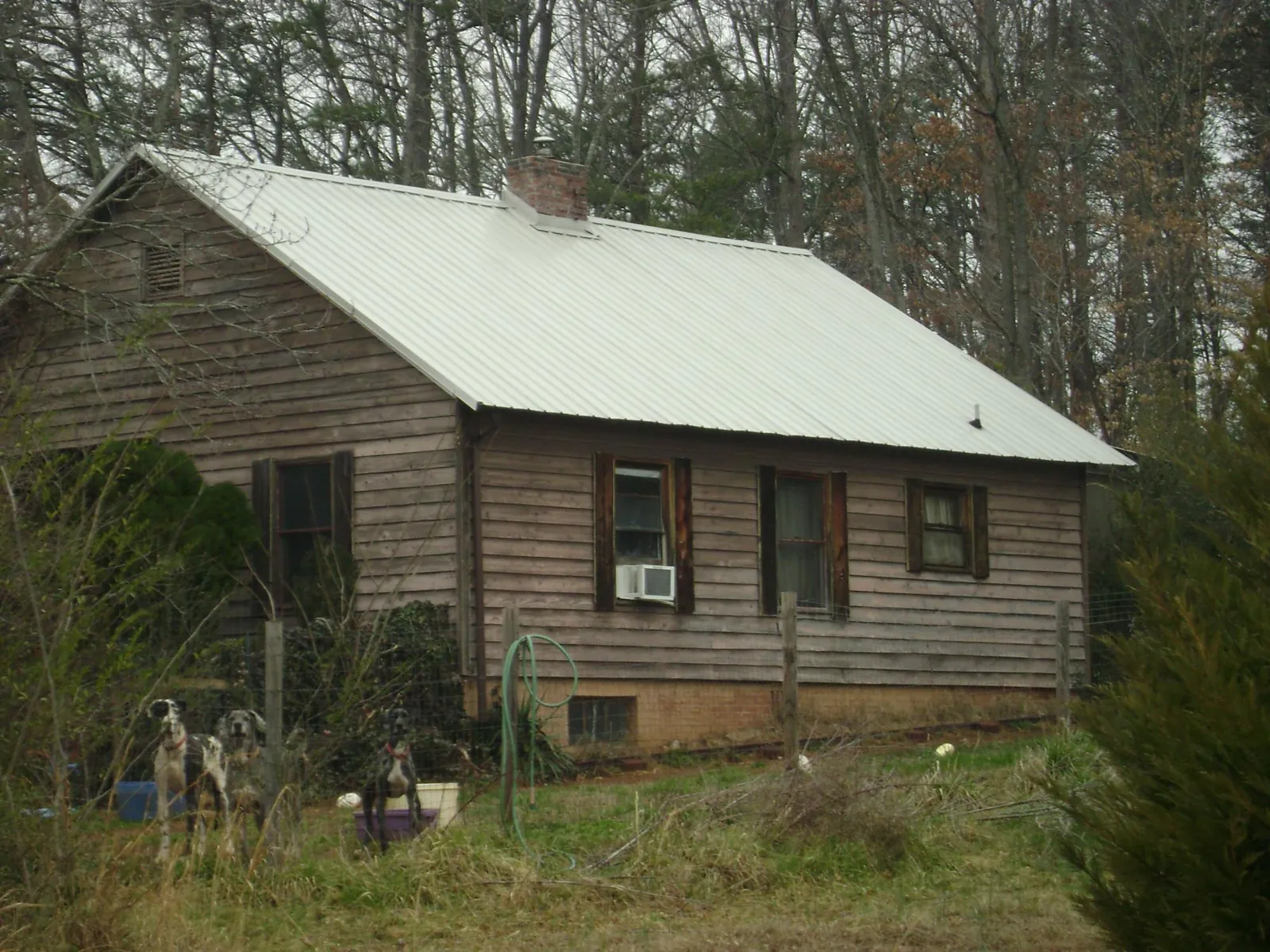 White metal roof on an old wood sided farmhouse, from a Asphalt Shingle Roof Repair job in West Lebanon